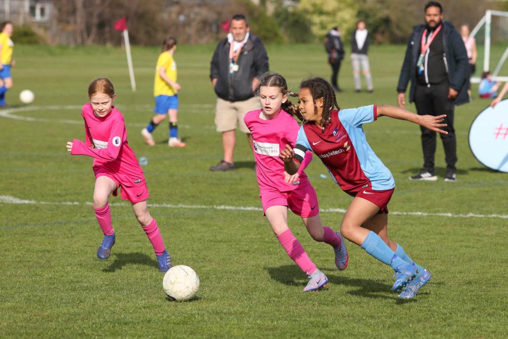 3 girls playing football