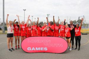Netball winning team with hands in the air