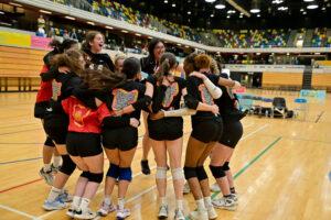 Group of volleyball girls jump in excitement