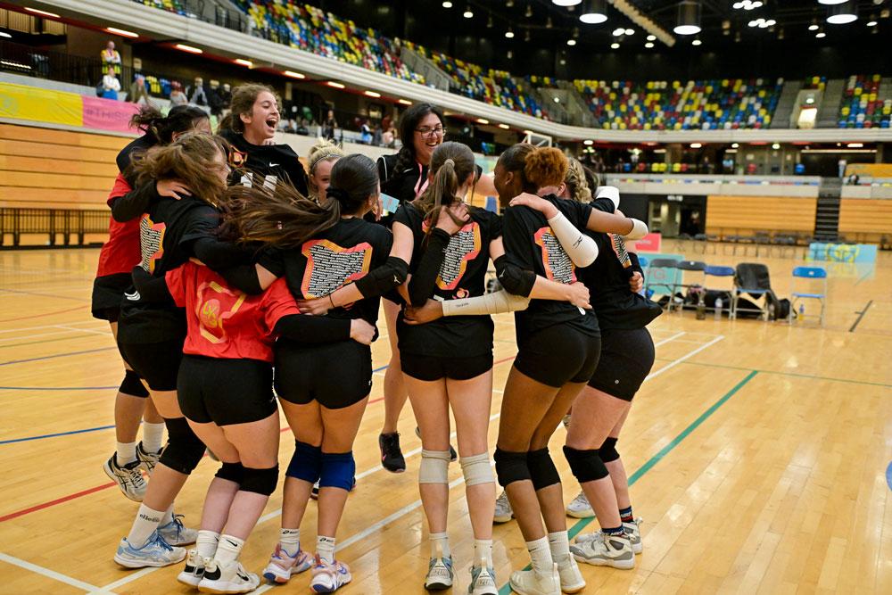 Group of volleyball girls jump in excitement