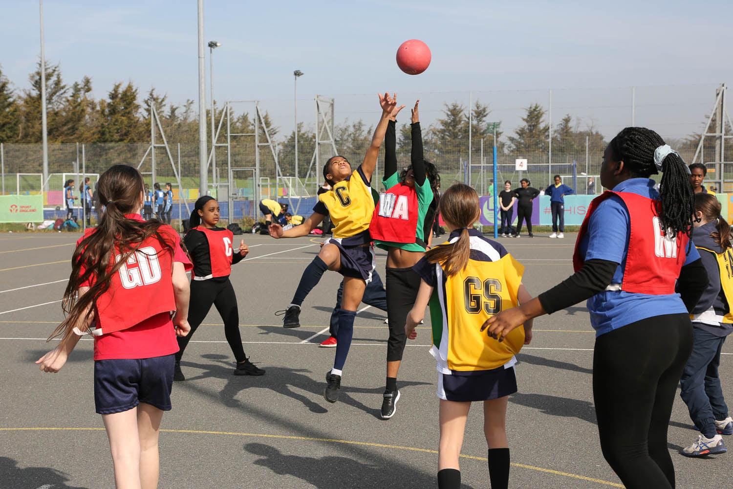 Young female basketball players practicing their skills on the court together.