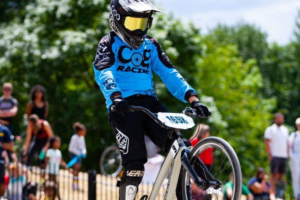 A cyclist riding a bike on a scenic mountain trail.