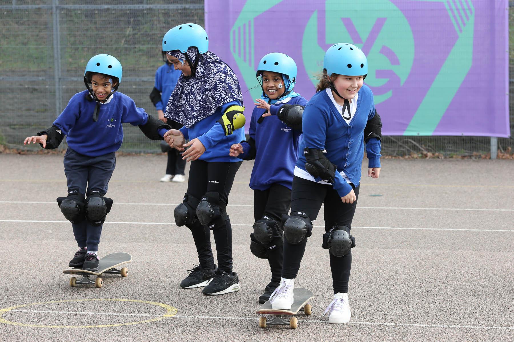 4 skateboarders smile