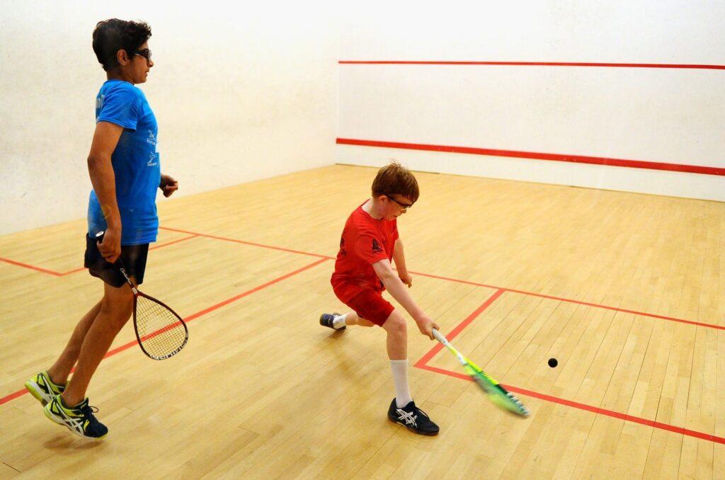 two kids playing squash