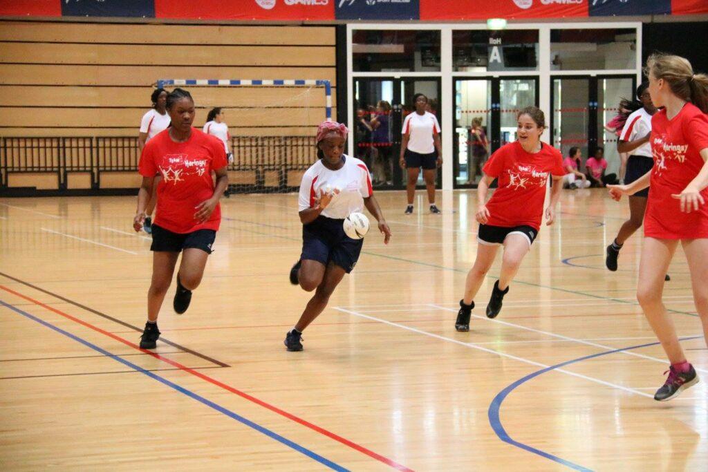 A group of girls playing handball.