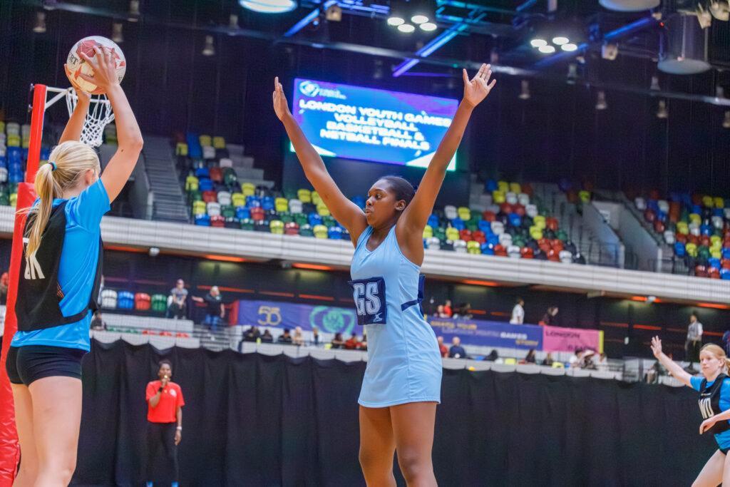 ethnically diverse girls play netball