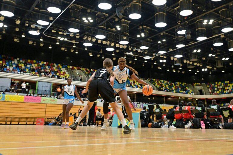 black female and white female play basketball