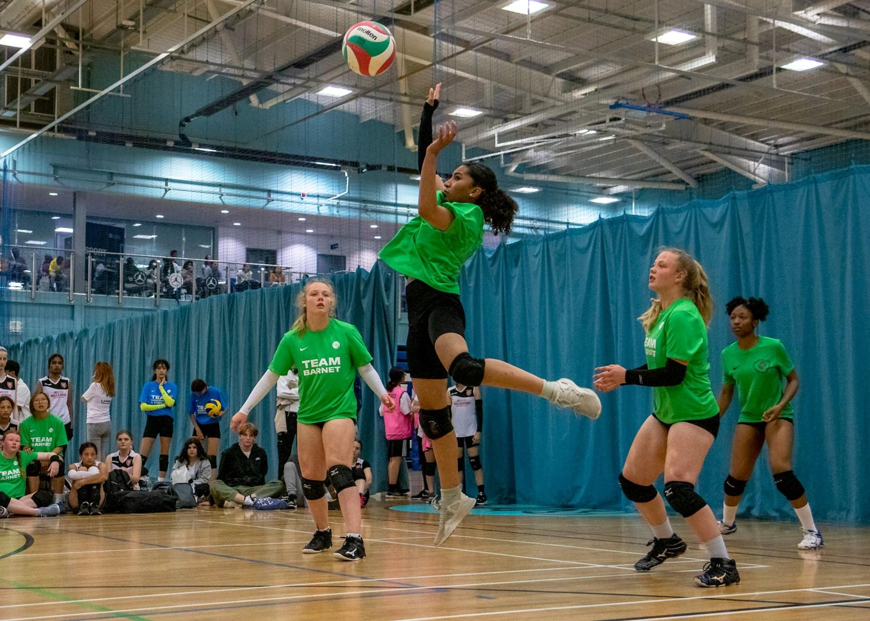 girls play volleyball