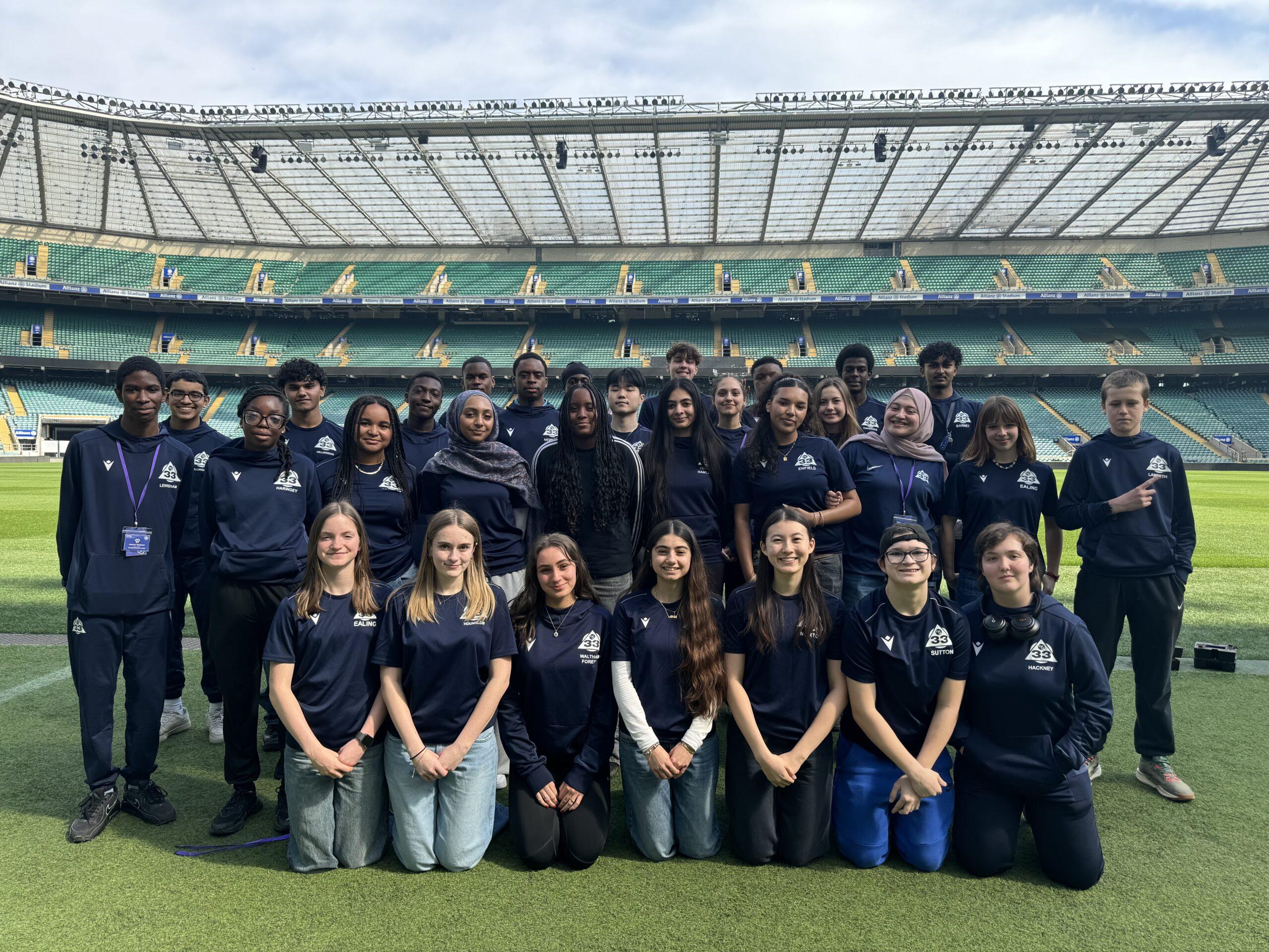 mixed ethnicity group smile at twickenham stadium
