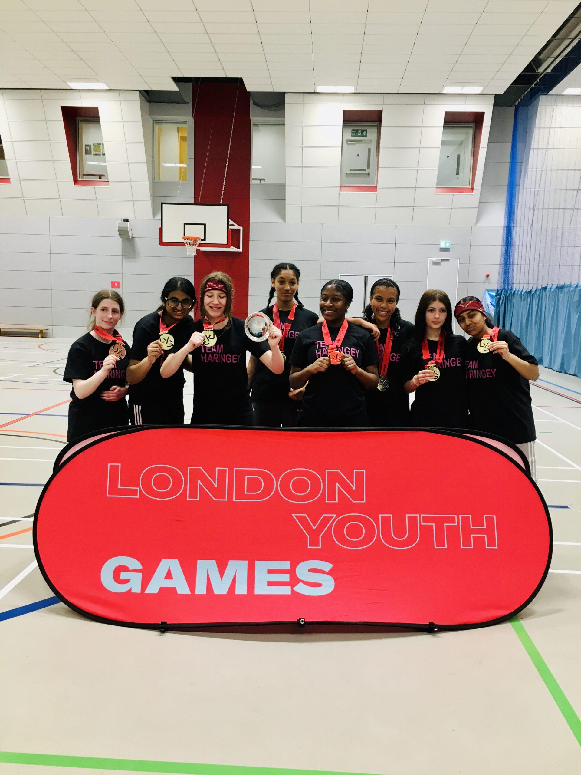 mixed ethnicity girls celebrate medals