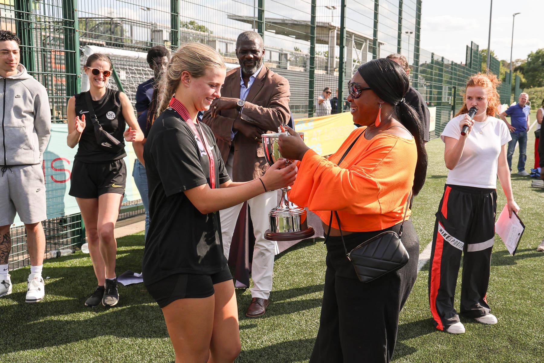 black female awards trophy to white female
