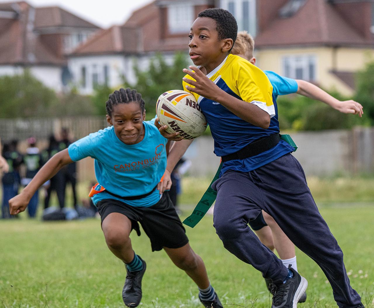 Boy running with Rugby ball
