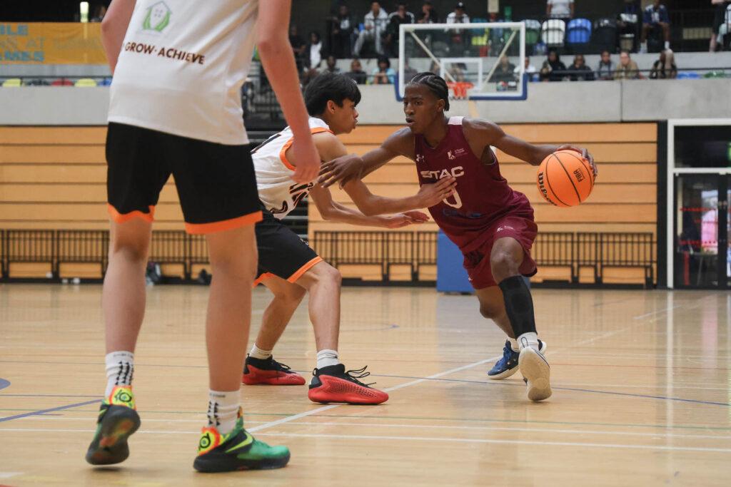 mixed ethnicity boys play basketball
