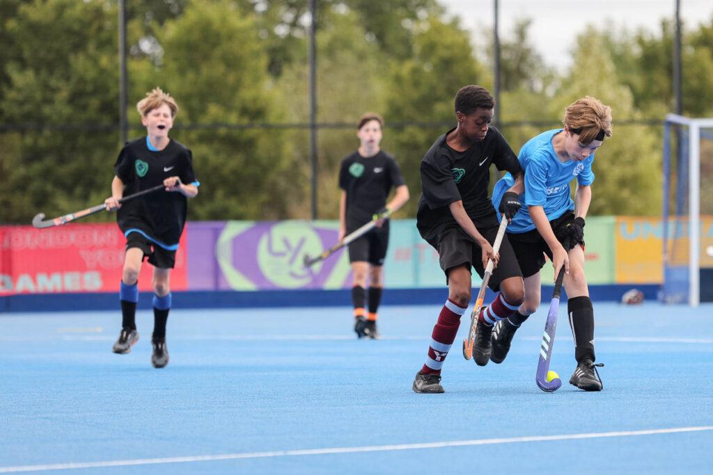 mixed ethnicity boys play hockey