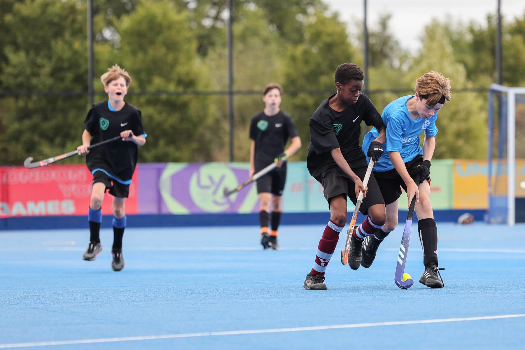 mixed ethnicity boys play hockey