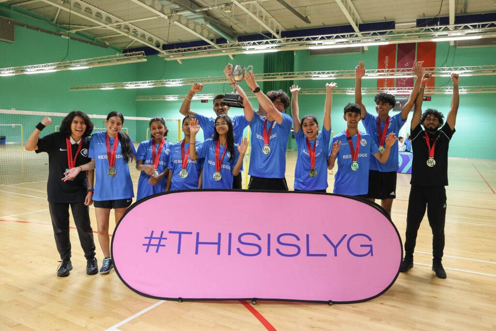 badminton players celebrate with trophy