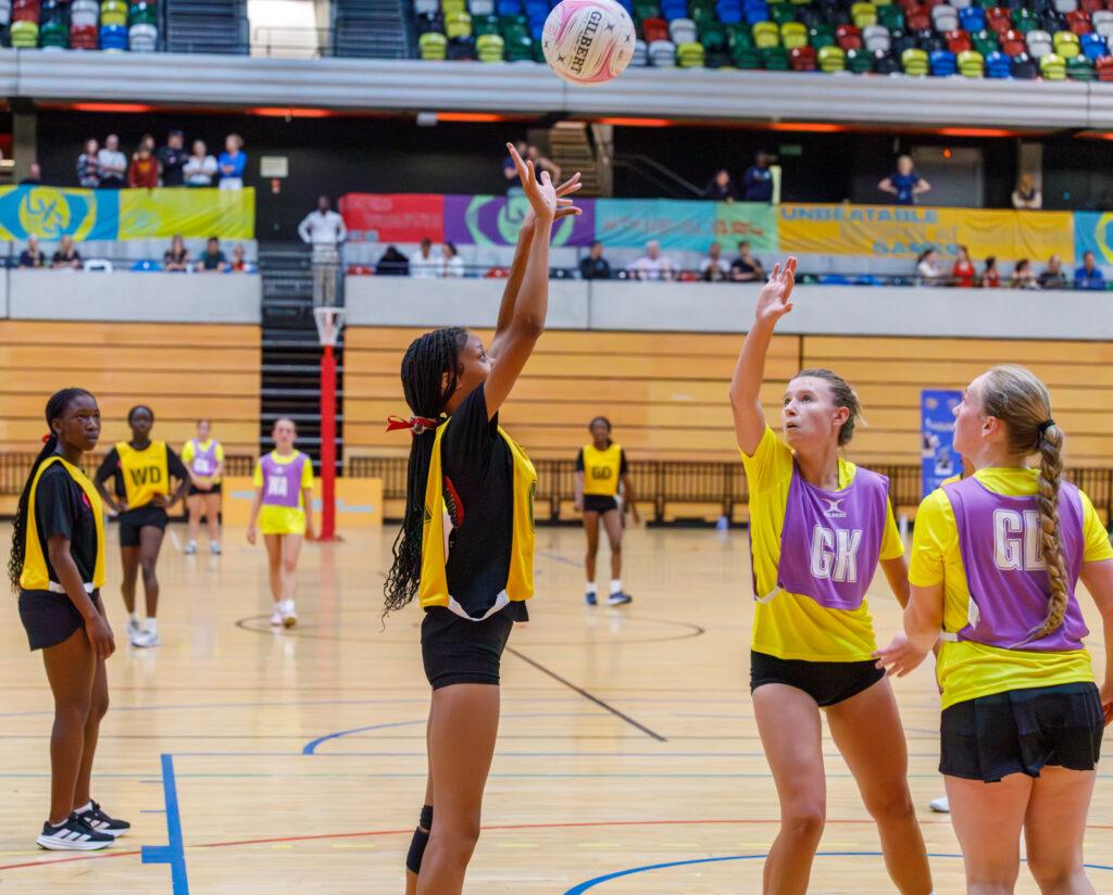 mixed ethnicity girls play netball