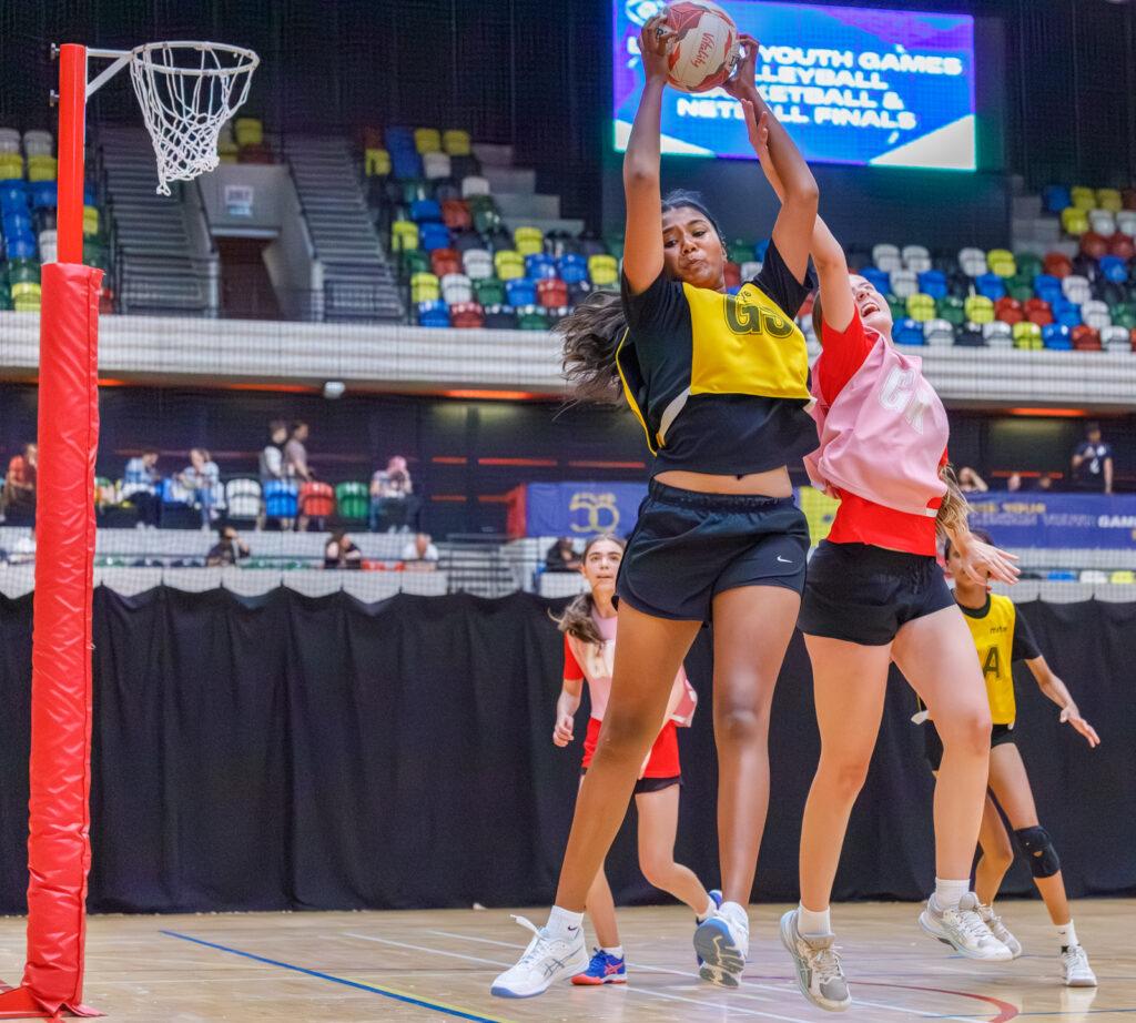 mixed ethnicity girls play netball
