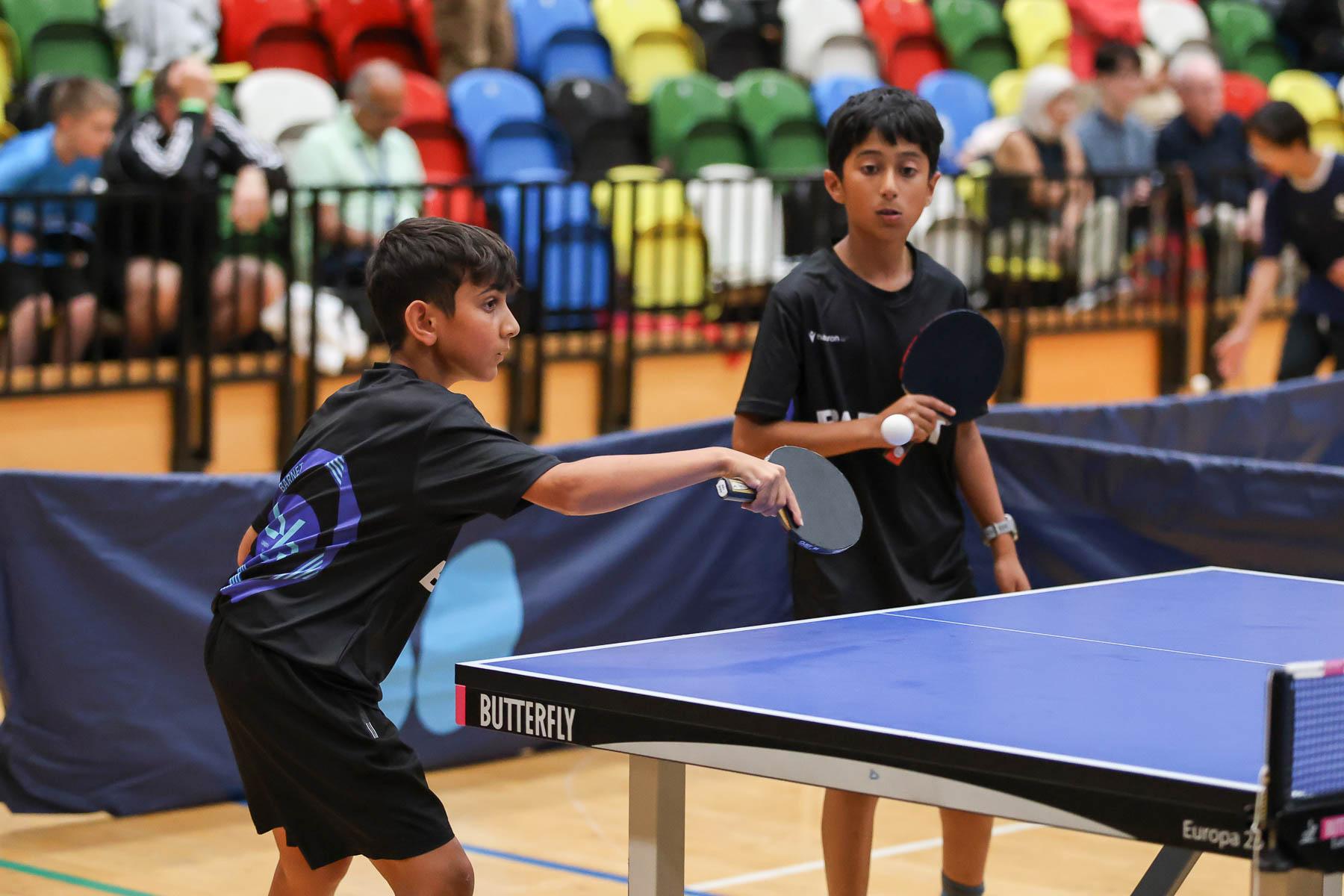 ethnically diverse boys play table tennis