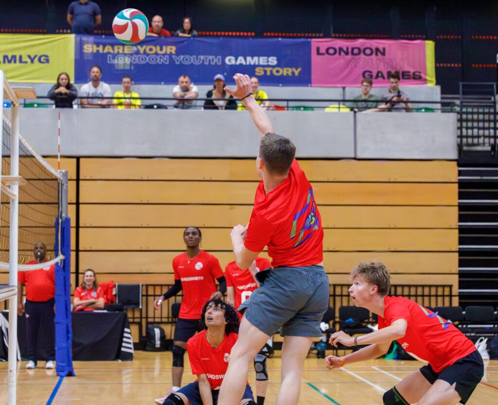 mixed ethnicity boys play volleyball