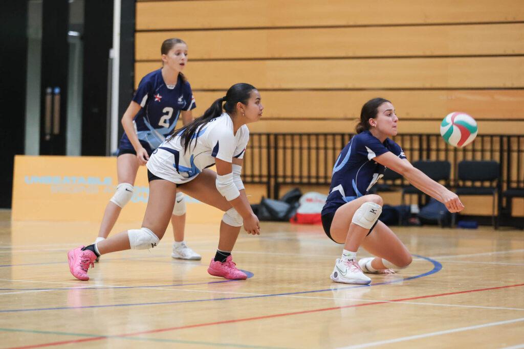 mixed ethnicity girls play volleyball
