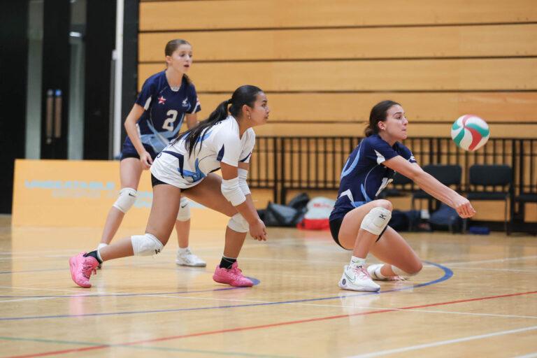 mixed ethnicity girls play volleyball