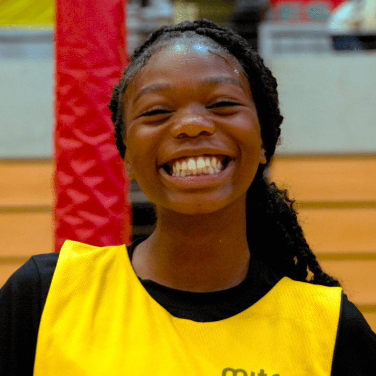 divine, black female smiles in yellow bib