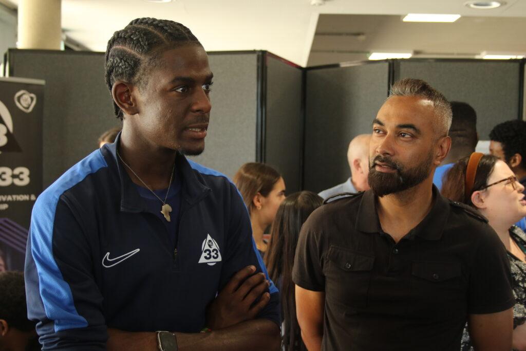 black male and brown skin male speaks