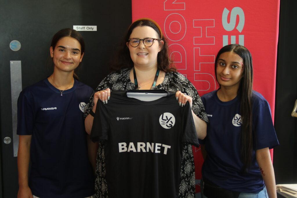 1 white female and 1 brown skin female young people smiles and poses with Barnet councillor and Barnet t shirt